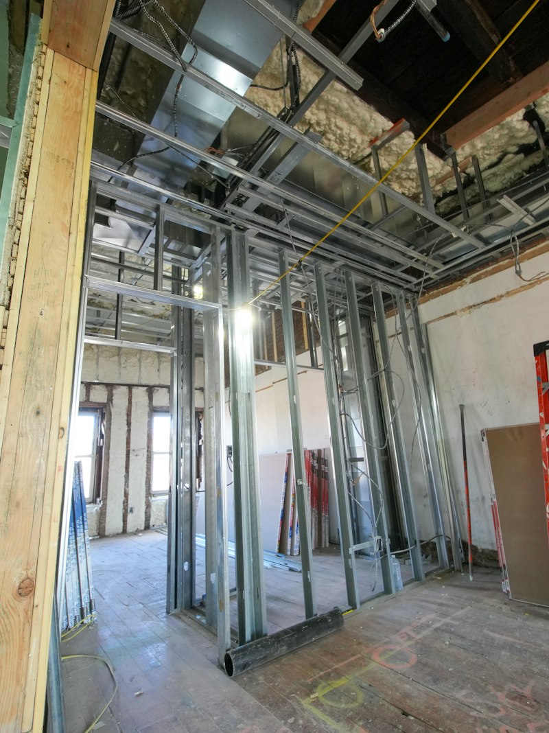 A steel stud wall framed out inside a building, ready for board — {{SERVICE_2}}